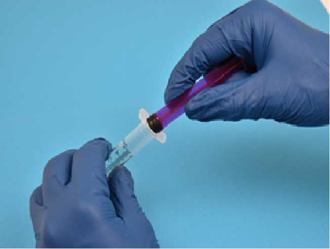 Shows plunger being placed back into the syringe